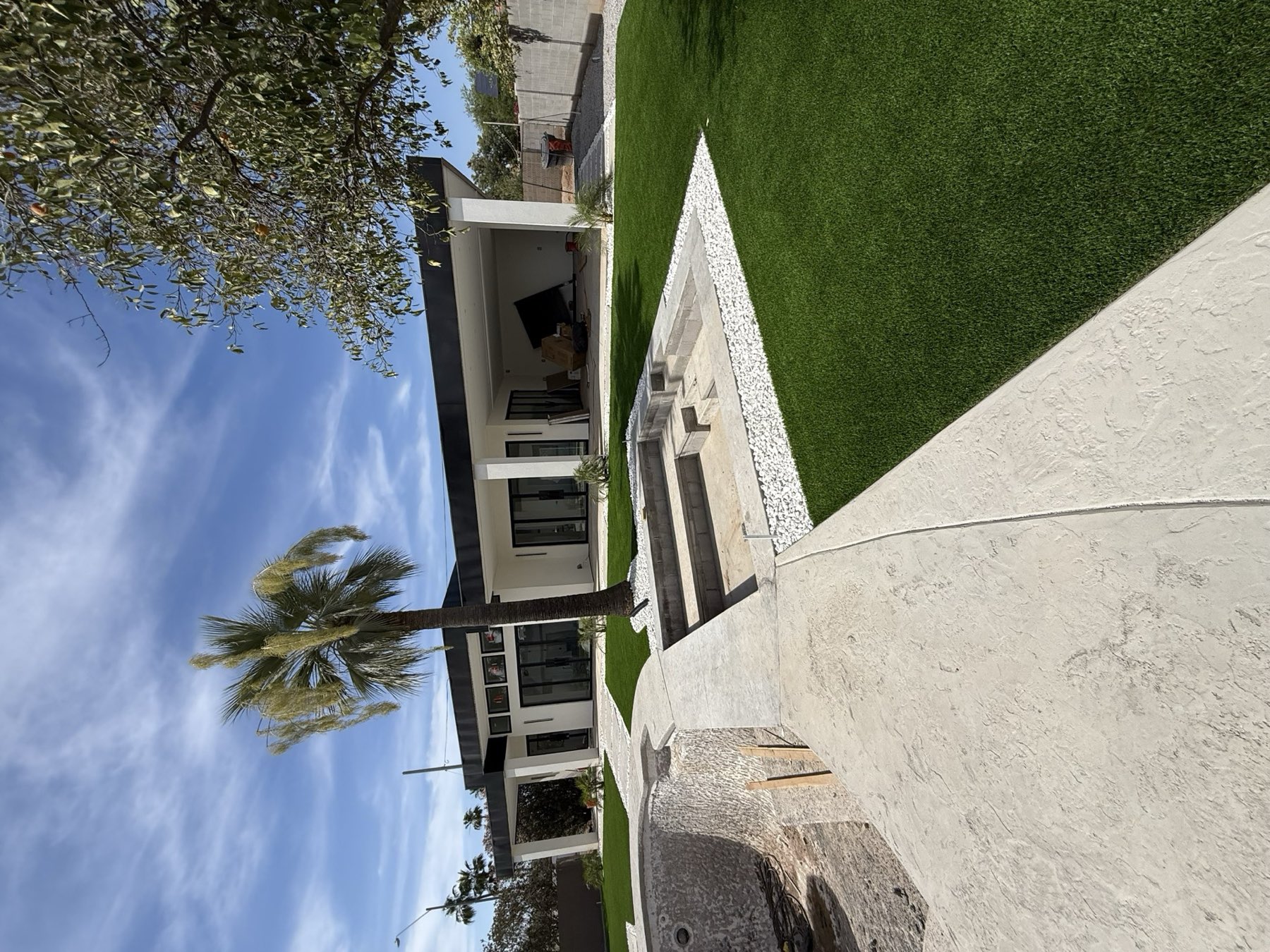 Modern desert home with sunken fire feature and travertine