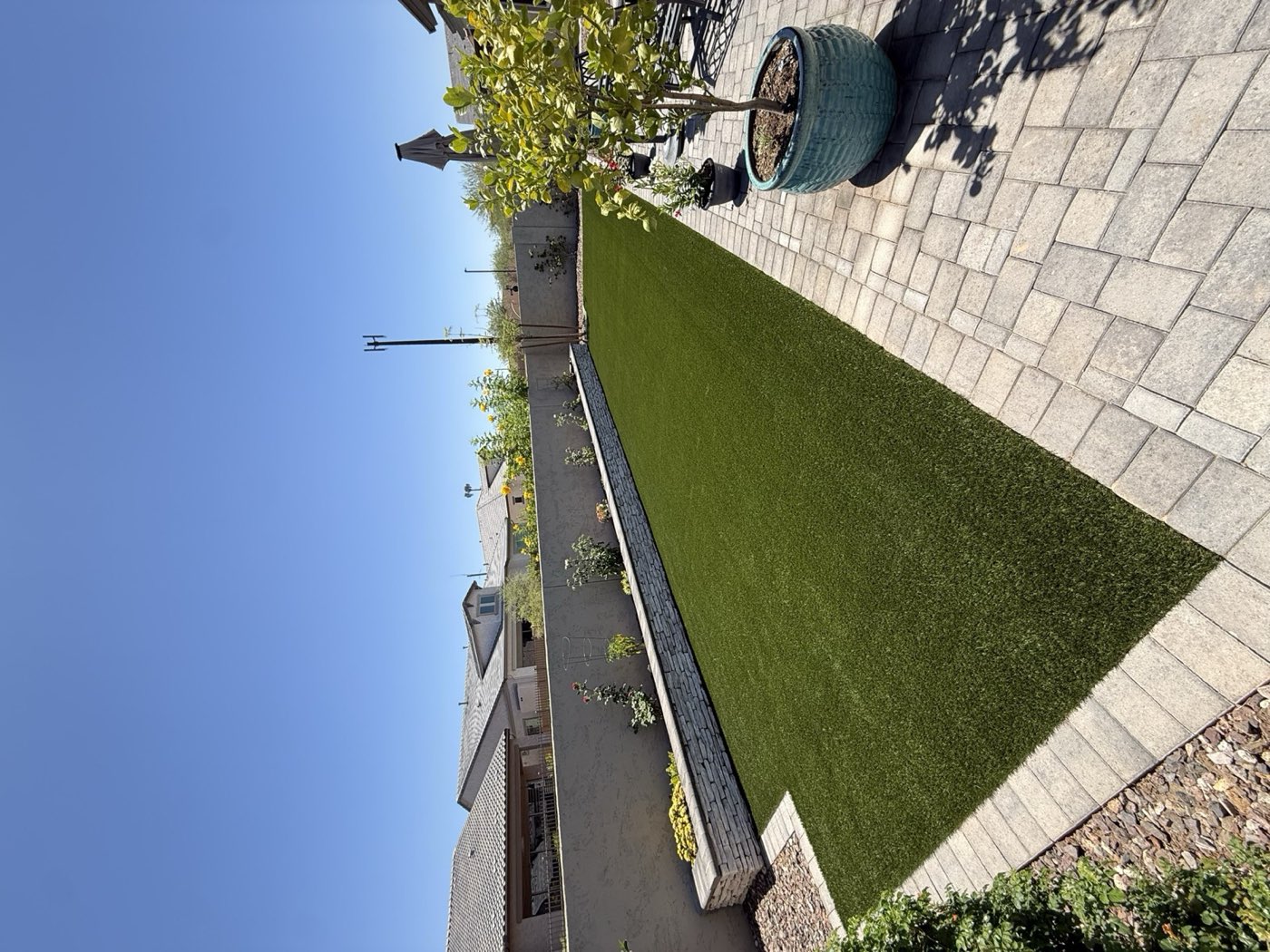 Artificial turf lawn with stacked-stone seat wall